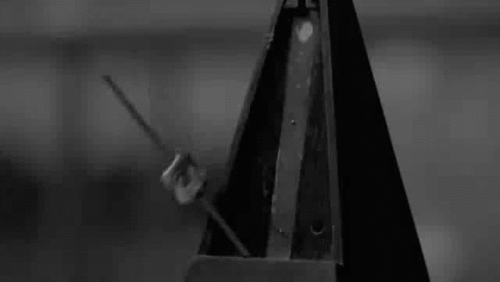 A metronome ticking back and forth, symbolizing the importance of consistent cadence and rhythm in leadership and teamwork